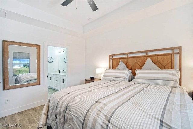 bedroom with ensuite bathroom, ceiling fan, and light hardwood / wood-style floors