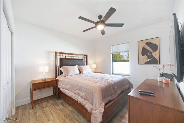 bedroom featuring hardwood / wood-style flooring, a closet, and ceiling fan