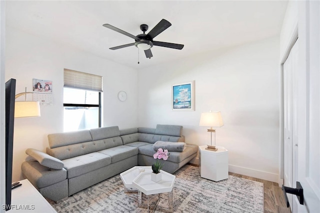 living room with hardwood / wood-style floors and ceiling fan