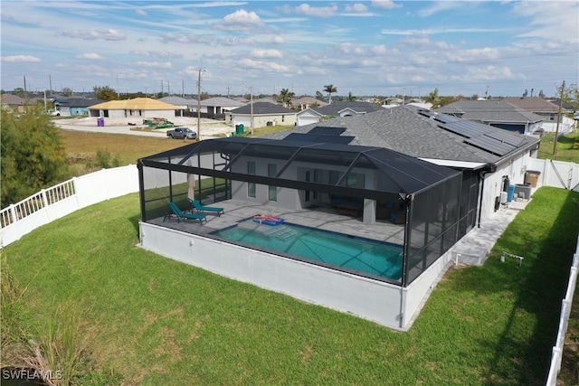 view of pool with a lawn, a lanai, and a patio