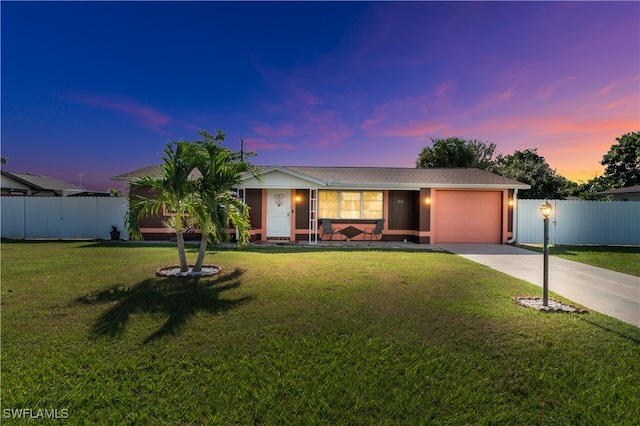 ranch-style home with a lawn and a garage