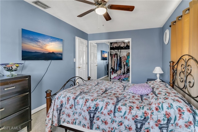 bedroom with ceiling fan, a closet, and light carpet