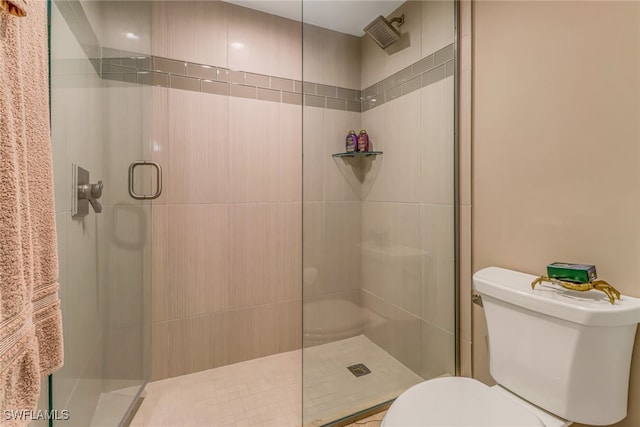 bathroom featuring toilet and walk in shower