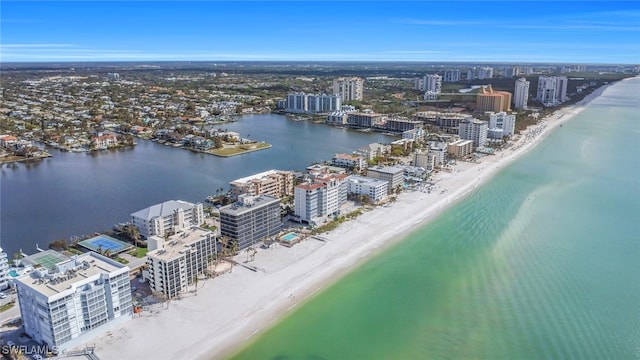 bird's eye view featuring a water view and a beach view