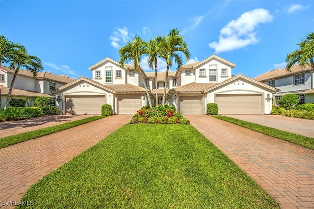 view of front of property with a front yard and a garage