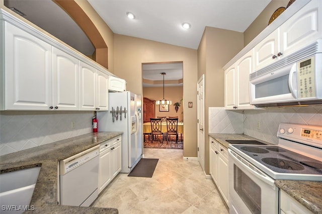 kitchen featuring white cabinetry, an inviting chandelier, lofted ceiling, white appliances, and decorative backsplash