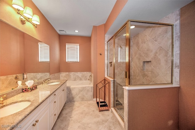 bathroom with tile patterned floors, vanity, and separate shower and tub