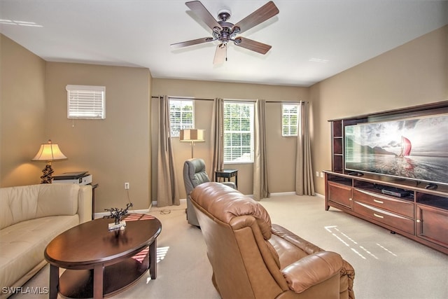 carpeted living room featuring ceiling fan