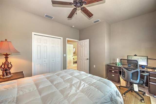 bedroom with light wood-type flooring, a closet, and ceiling fan