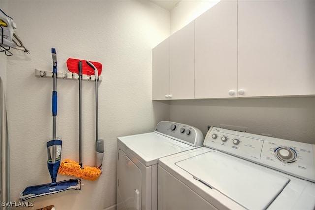 laundry area featuring cabinets and washing machine and clothes dryer