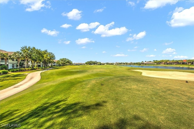 view of community featuring a water view and a lawn