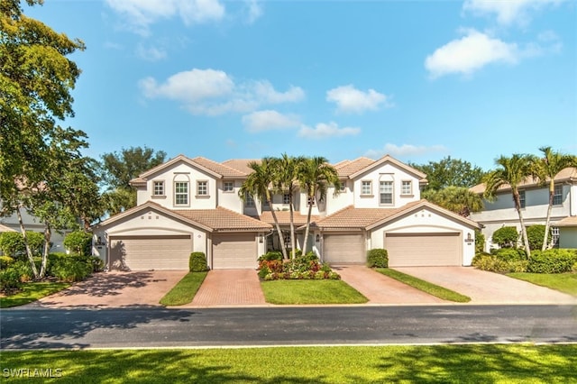 view of front of home with a front yard and a garage