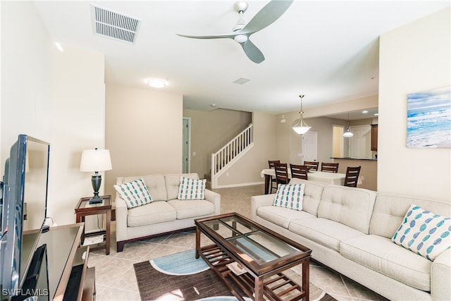 tiled living room featuring ceiling fan