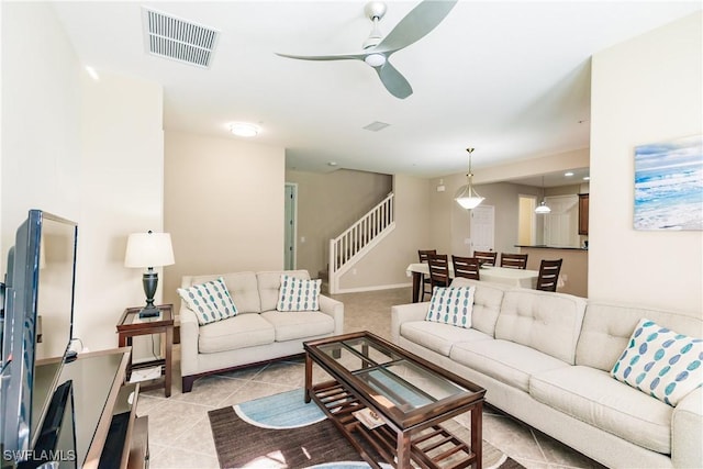 9028 Alturas St Unit 3204, Naples, FL 34113 - living area with ceiling fan, stairway, light tile patterned floors, and baseboards