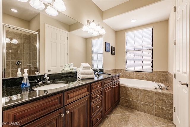 bathroom with tile patterned floors, vanity, and separate shower and tub