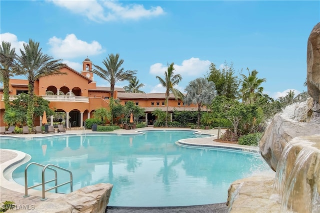 view of swimming pool with a patio area and pool water feature