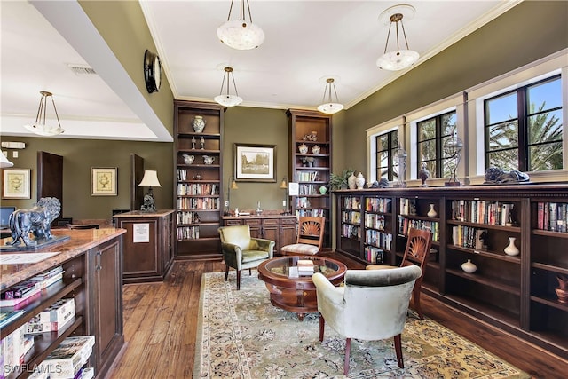 living area featuring dark hardwood / wood-style flooring and ornamental molding