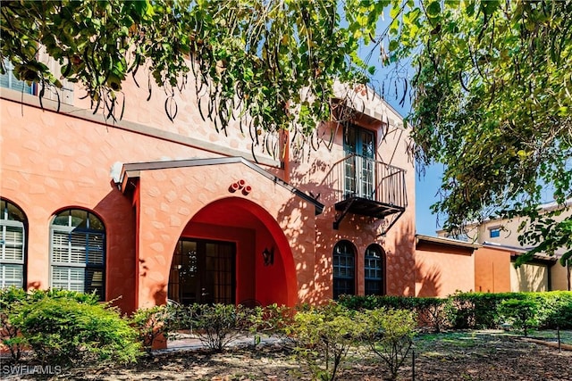 9028 Alturas St Unit 3204, Naples, FL 34113 - property entrance with a balcony, french doors, and stucco siding