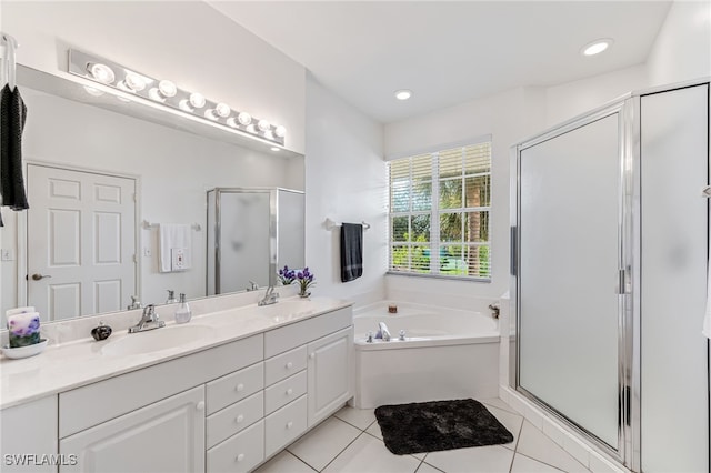 bathroom featuring tile patterned flooring, shower with separate bathtub, and vanity