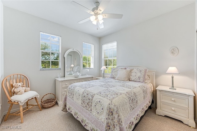 bedroom with ceiling fan and light colored carpet