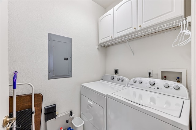 washroom featuring washer and clothes dryer, cabinets, and electric panel