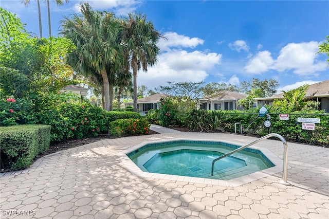 view of pool with a hot tub