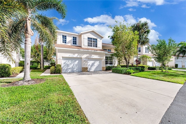 view of front of property with a front yard and a garage