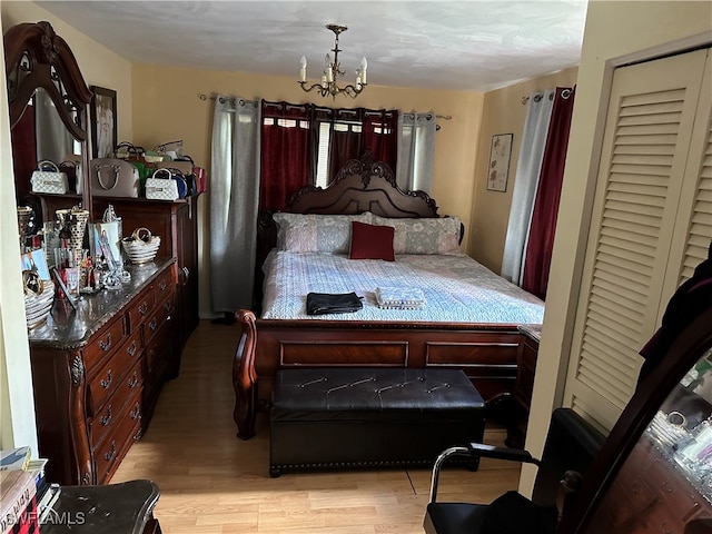 bedroom featuring a chandelier and light hardwood / wood-style flooring