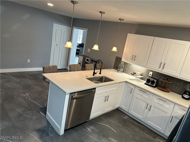 kitchen featuring dishwasher, pendant lighting, white cabinetry, and lofted ceiling