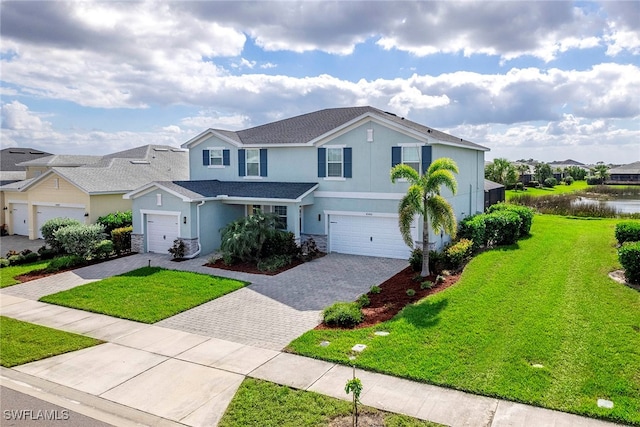 view of property with a garage and a front lawn