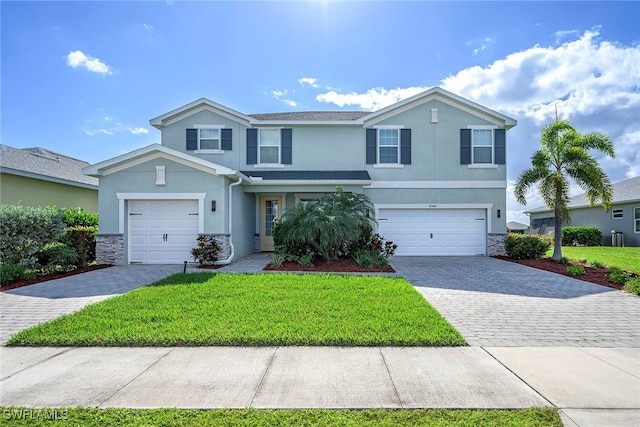 view of front of property with a garage and a front lawn