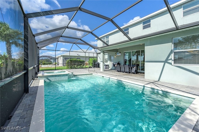 view of pool with an in ground hot tub, a patio area, and a lanai