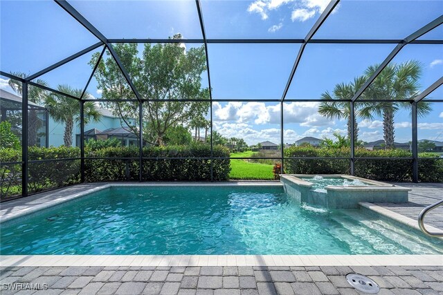 view of swimming pool with an in ground hot tub and a lanai