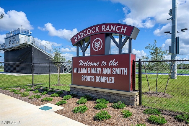 community sign featuring a yard