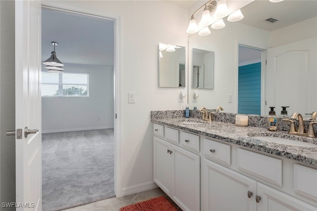 bathroom featuring tile patterned flooring and vanity