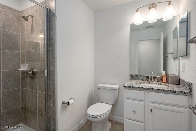 bathroom with an enclosed shower, vanity, and toilet