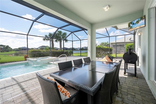 view of patio featuring glass enclosure and a pool with hot tub