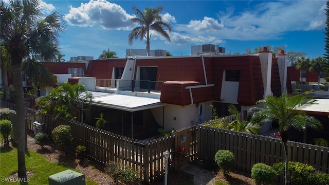 rear view of property featuring a balcony and central air condition unit