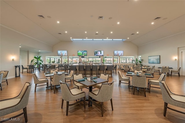 dining space with light wood-type flooring and visible vents