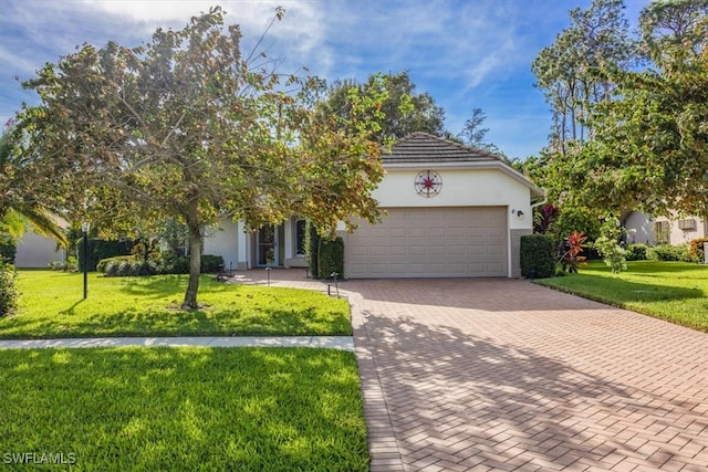 view of property hidden behind natural elements featuring a garage and a front yard