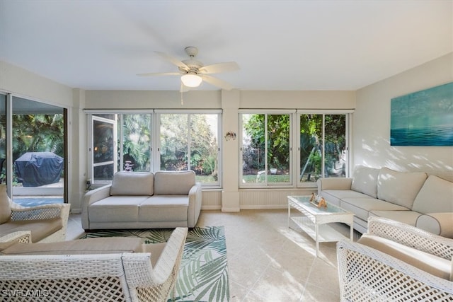 sunroom / solarium with a ceiling fan