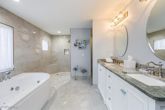 full bathroom with a whirlpool tub, marble finish floor, walk in shower, and a sink