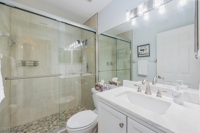 full bath featuring vanity, toilet, and a shower stall