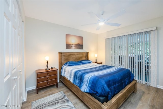 bedroom with ceiling fan, baseboards, and light wood-style flooring