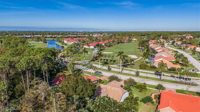 birds eye view of property featuring view of golf course and a water view