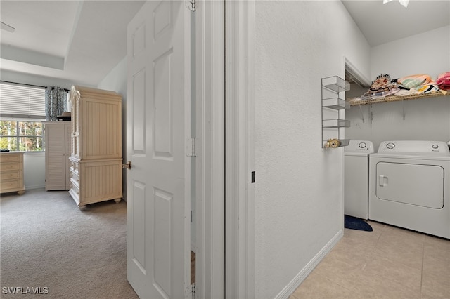 interior space featuring light carpet and separate washer and dryer