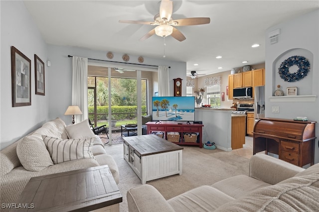 carpeted living room featuring ceiling fan and plenty of natural light