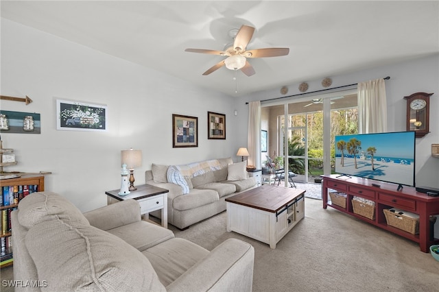 carpeted living room with ceiling fan