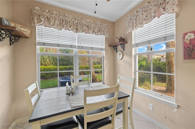 tiled dining space with ceiling fan