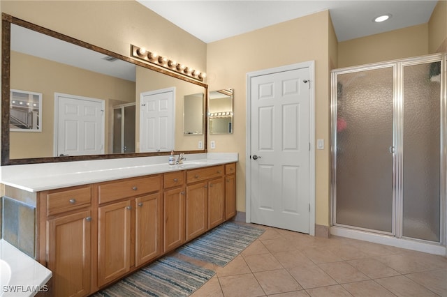 bathroom featuring vanity, tile patterned floors, and an enclosed shower